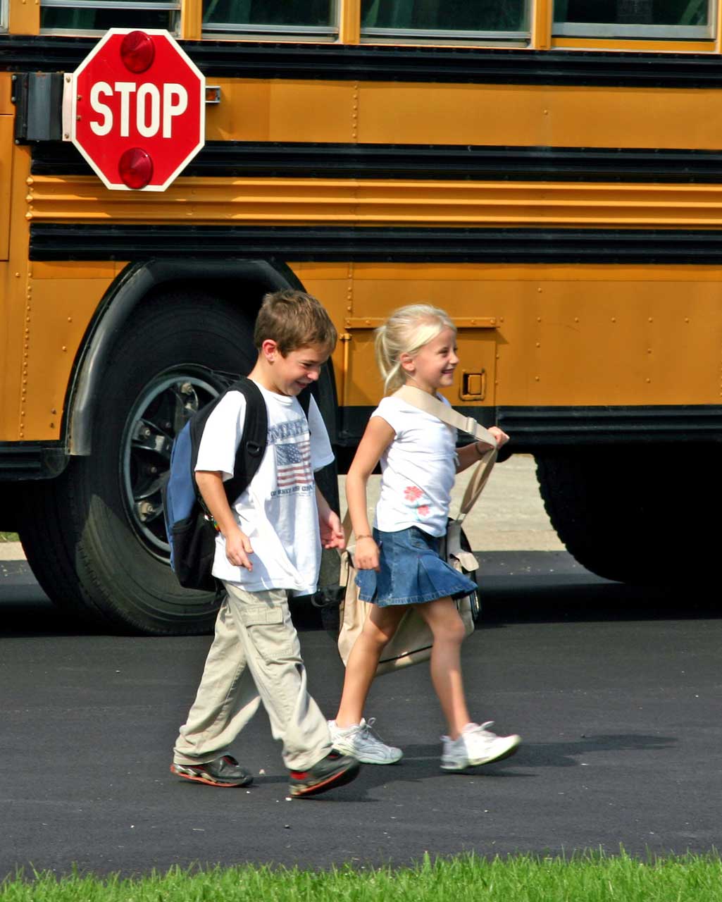 children-getting-off-bus-portrait