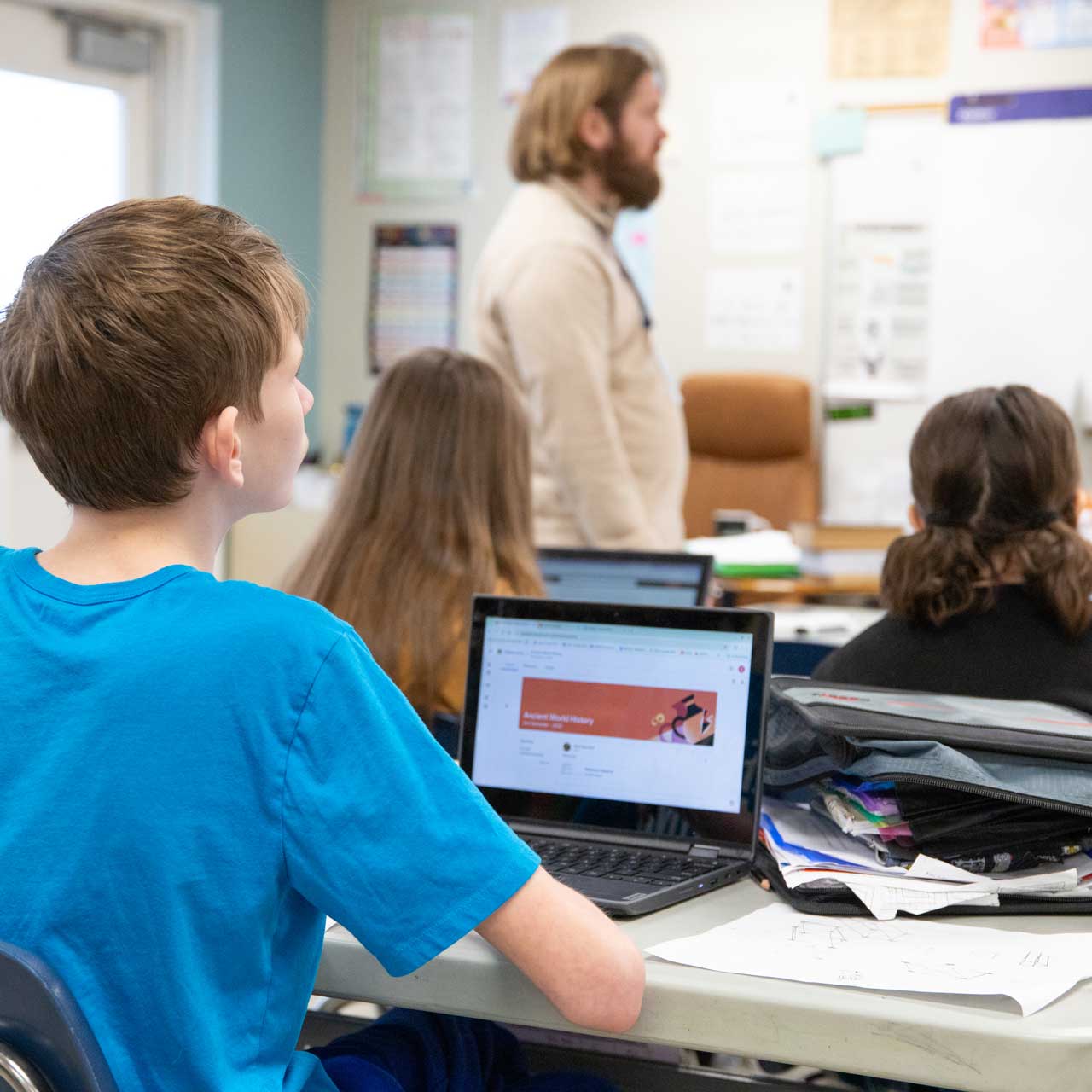 students-following-along-on-laptops-square