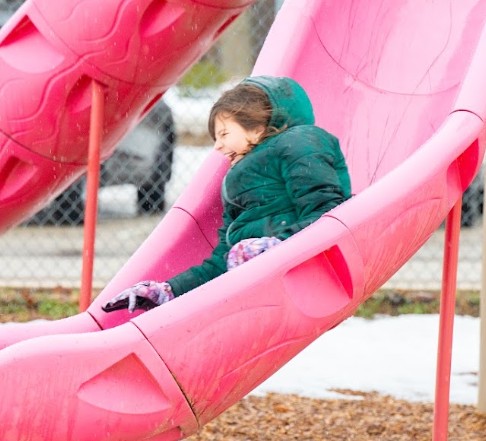 Girl sliding down slide